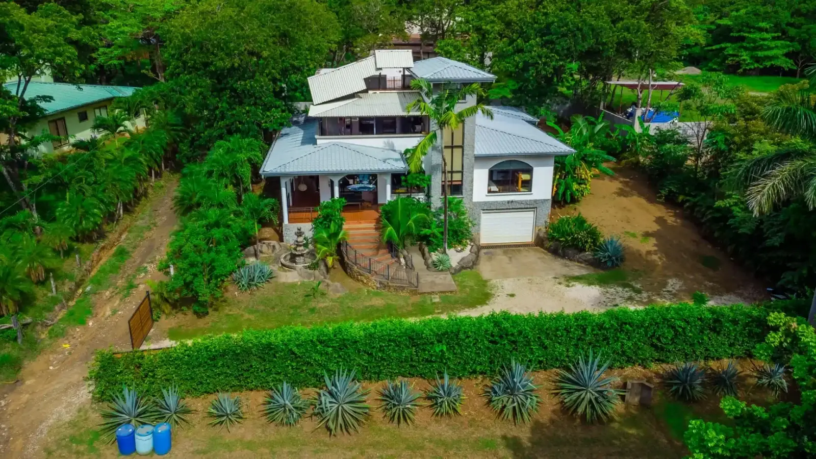 Aerial view of Casa Alice surrounded by tropical gardens in Playa Marbella