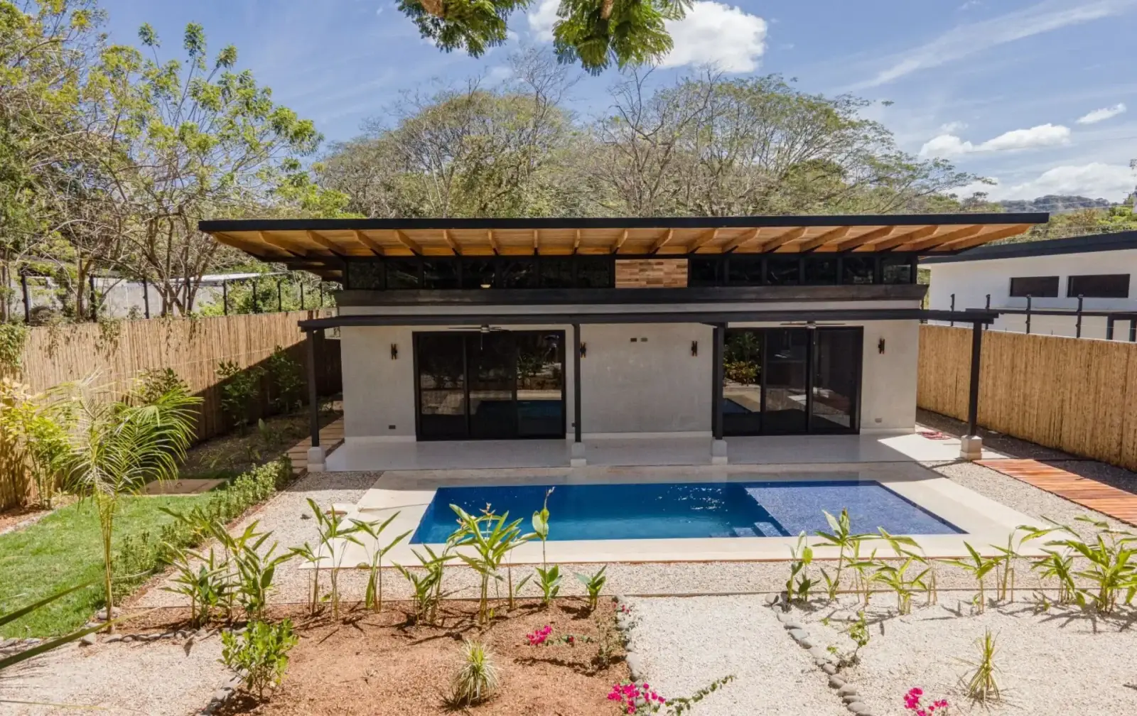 Contemporary single-storey home opening onto a pool terrace at El Refugio de Huacas