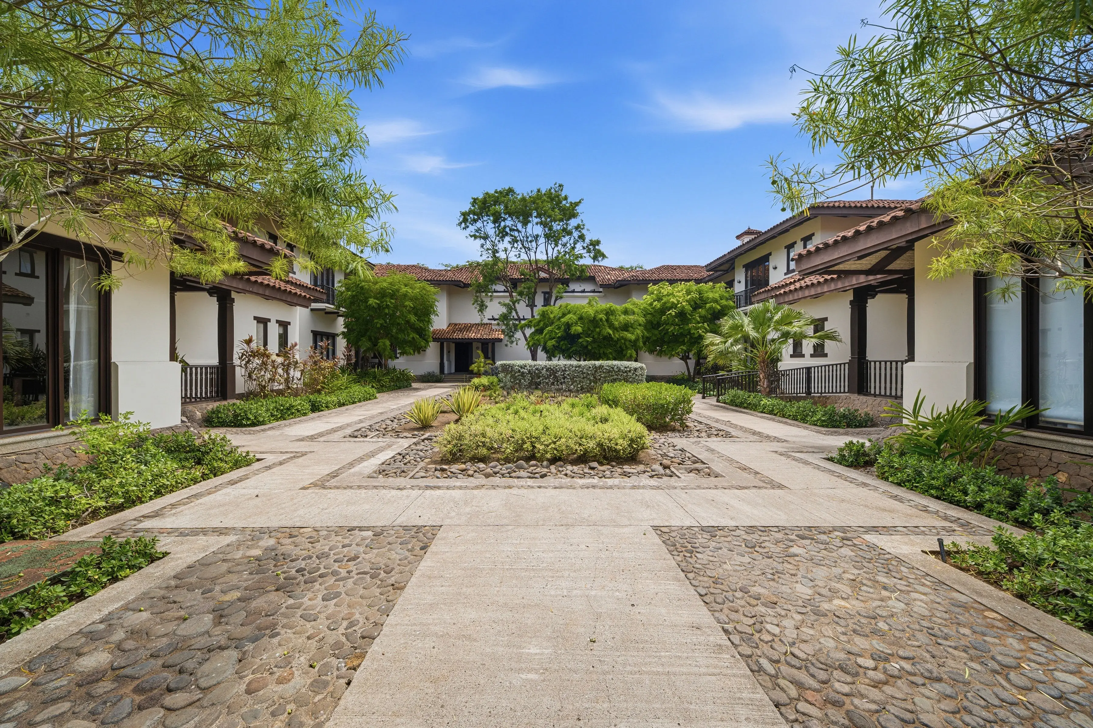 Colonial-style villa with tiled roof and mature gardens at Los Malinches, Hacienda Pinilla