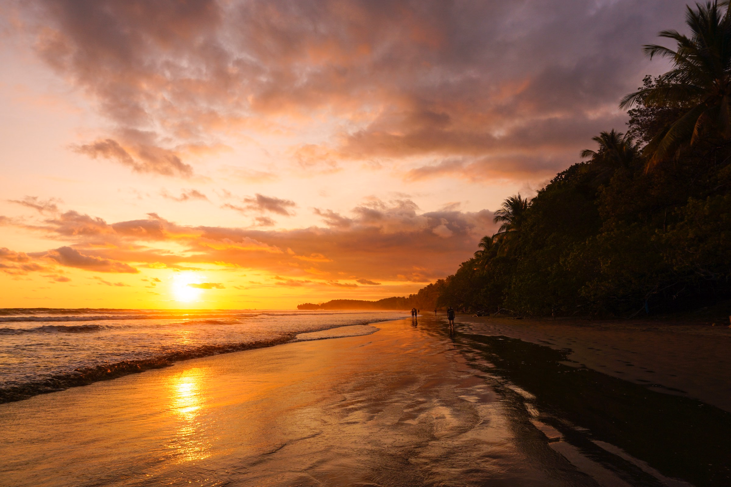 Sun setting into the Pacific over an empty Costa Rican beach